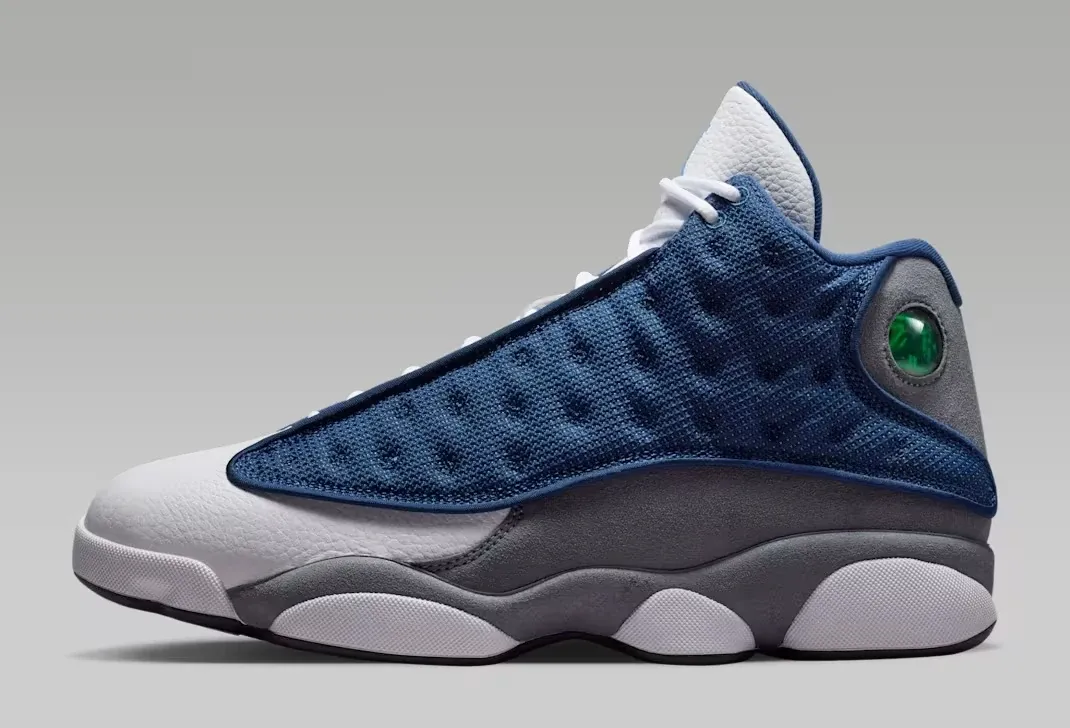 Medial side view of the Air Jordan 13 "Flint" (2026) in Navy, University Blue, Flint Grey and White.