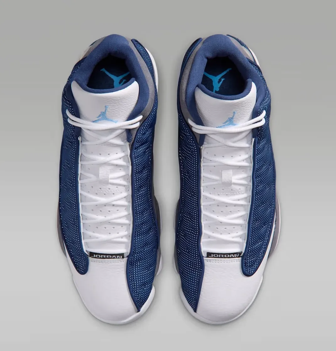 Top view of the Air Jordan 13 "Flint" (2026) featuring white leather and University Blue Jumpman branding.