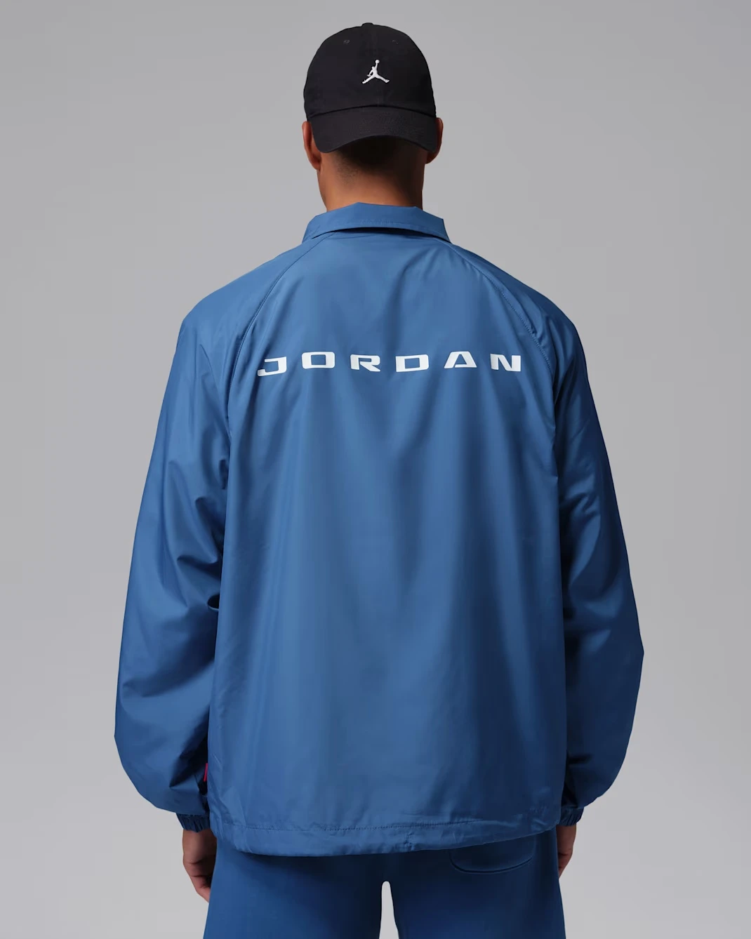Back view of a blue Jordan Coaches Jacket matching the Air Jordan 3 True Blue.