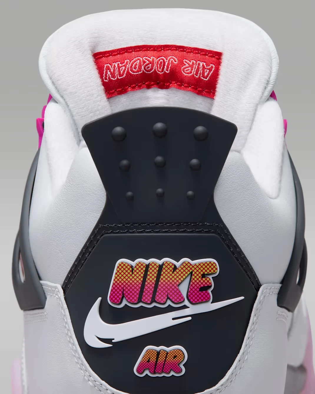 Close-up of the Nike Air comic-style heel branding on the Air Jordan 4 Comic Off-White Anthracite Fire Pink.