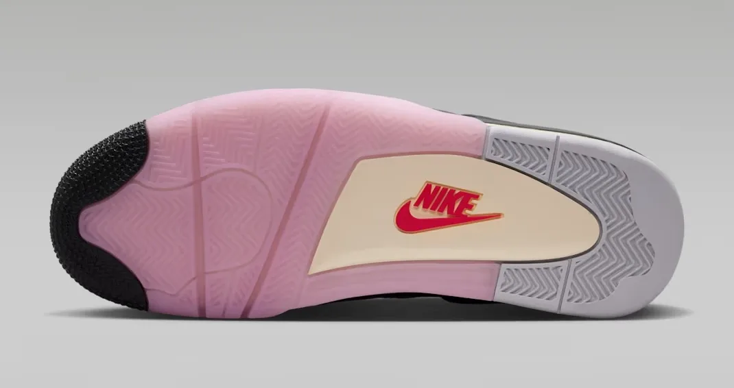 Bottom view of the Air Jordan 4 Comic outsole with pink rubber traction, grey sections and red Nike logo.