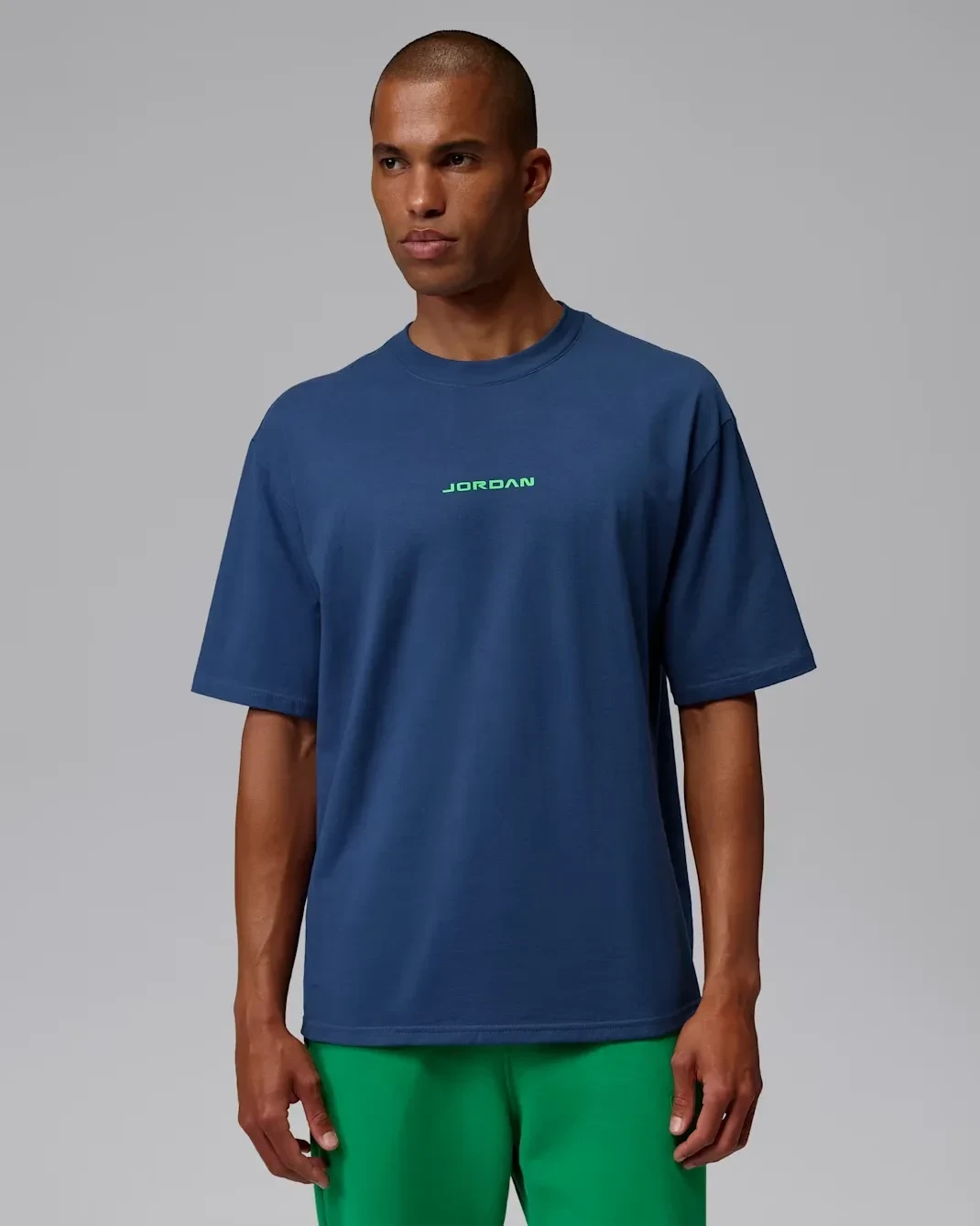 Front view of the Jordan AJ13 T-Shirt in French Blue with green Jordan logo, matching the Air Jordan 13 "Flint" (2026).