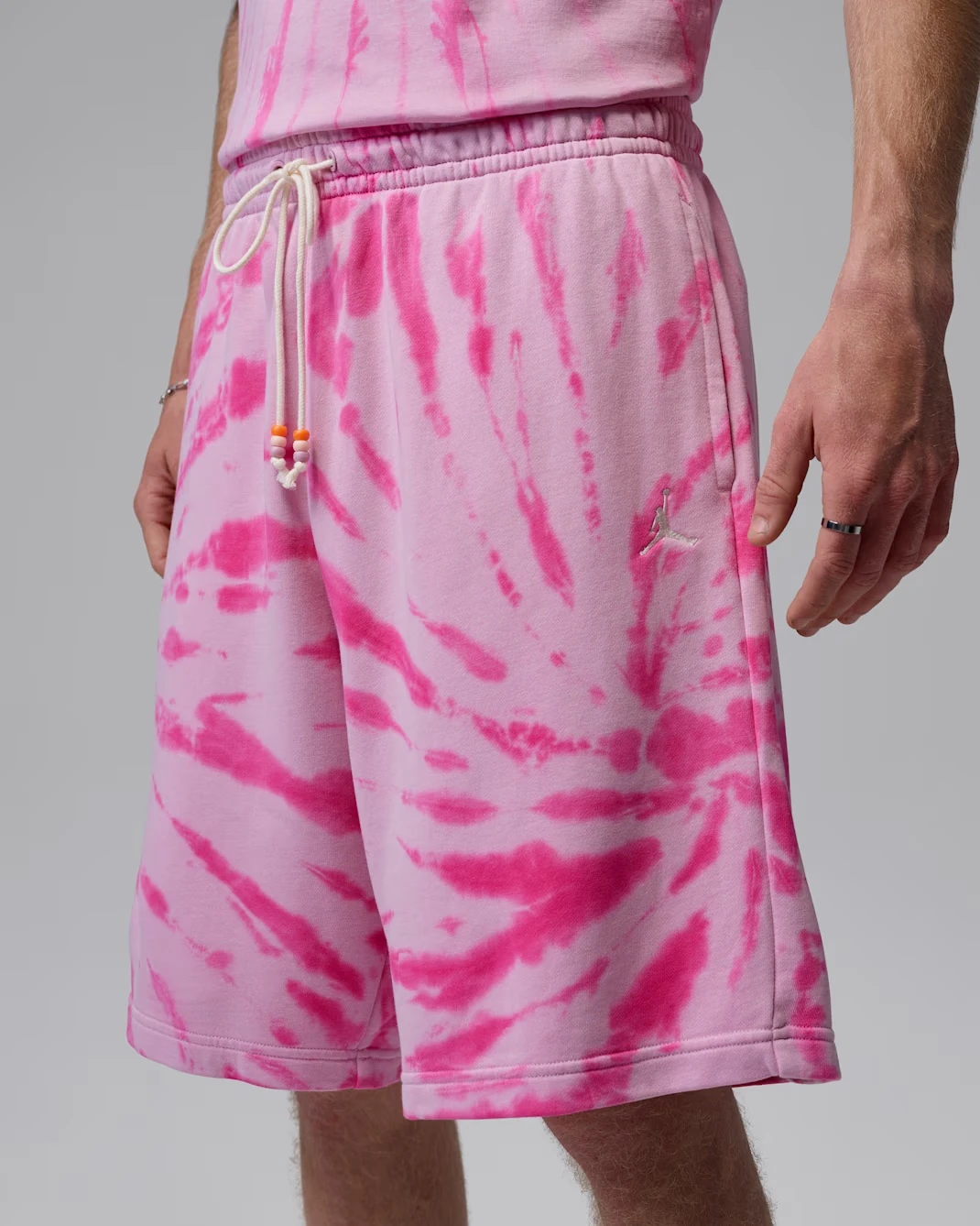 Close-up of the Jordan Brooklyn Fleece Festival Shorts in Iced Carmine, Pinksicle and Pale Ivory tie-dye.