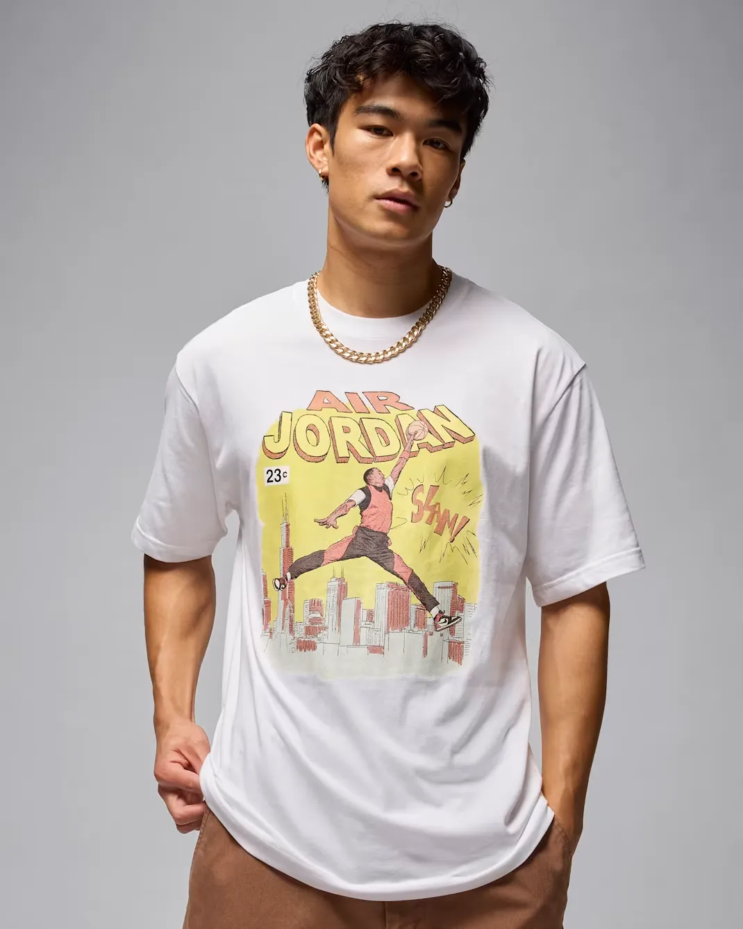 Model wearing the white Jordan Comic T-Shirt featuring a vintage comic book-inspired Air Jordan graphic on the front.