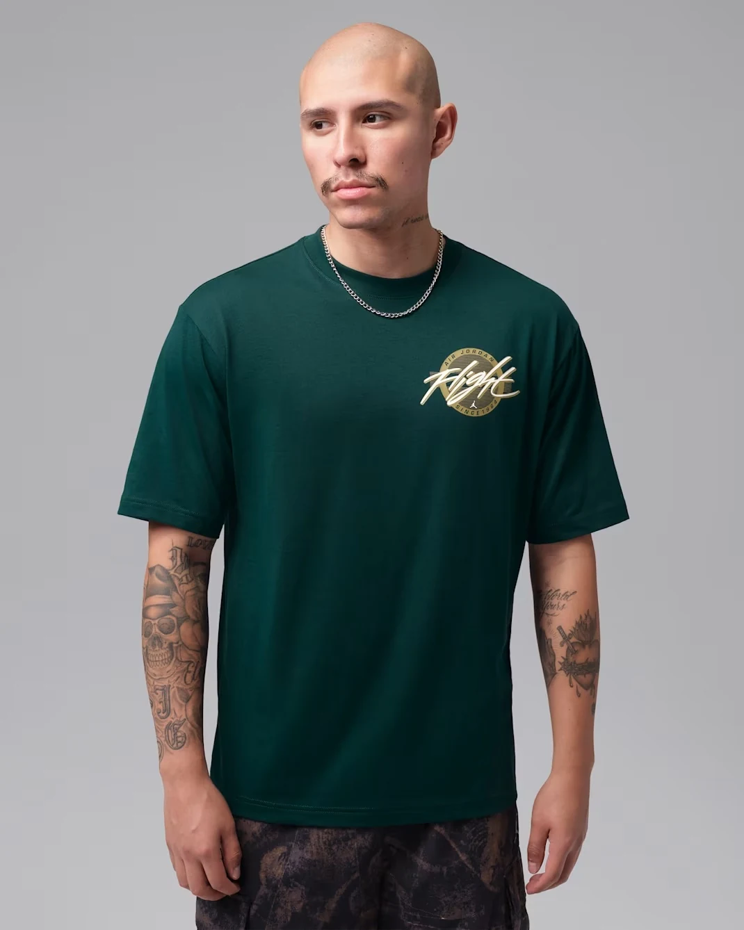 Model wearing the Jordan Flight T-shirt in Midnight Spruce with a Flight graphic on the chest.