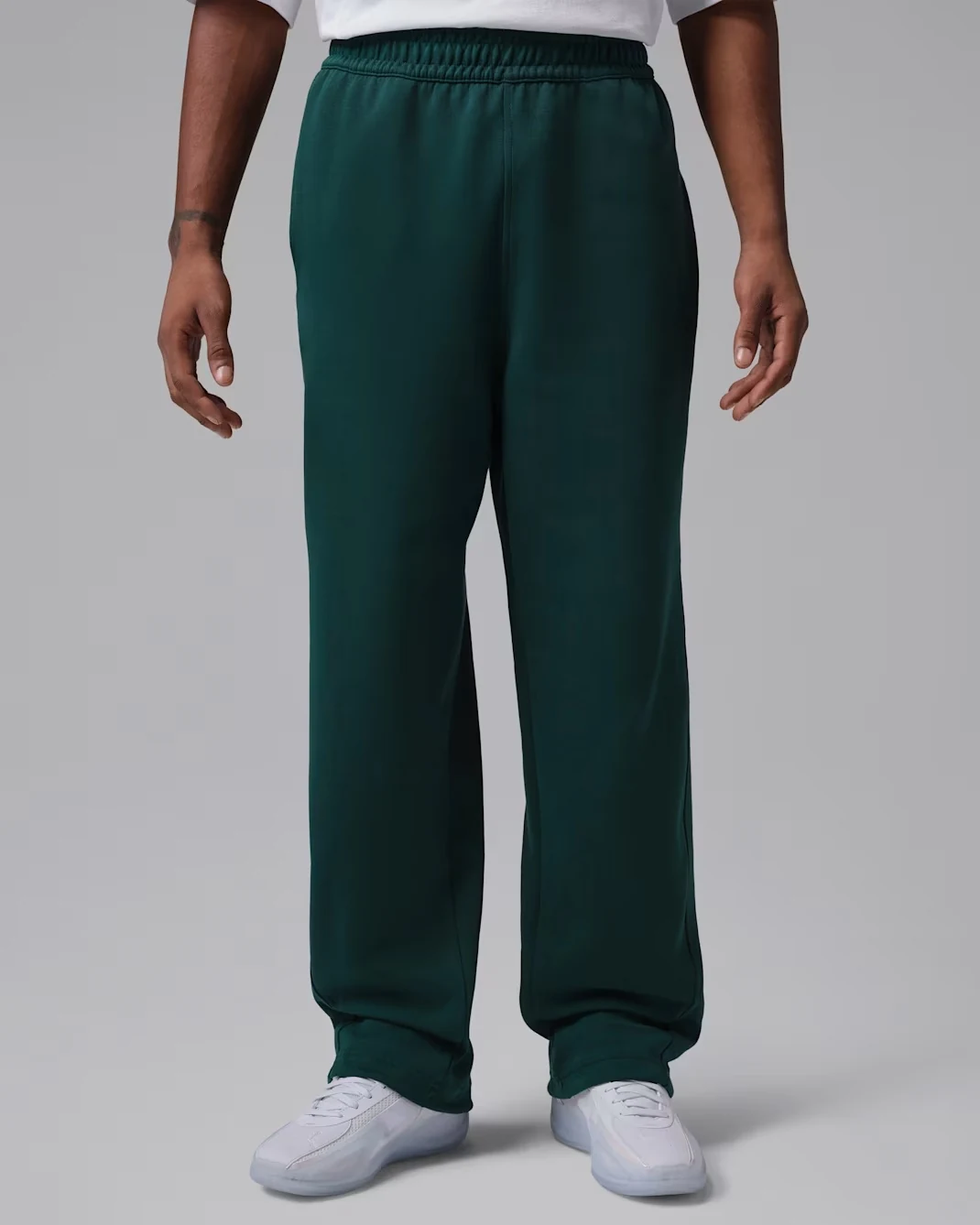 Model wearing Jordan Sport Hoop Fleece Dri-FIT pants in Midnight Spruce.