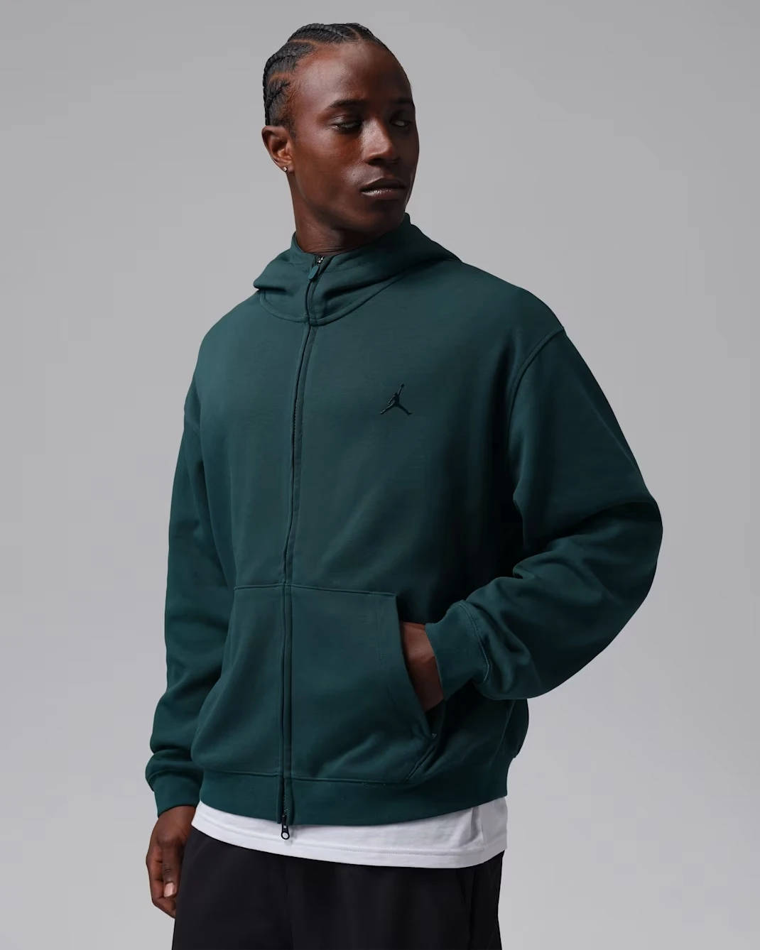 Model wearing the Jordan Sport Hoop Fleece full-zip hoodie in Midnight Spruce with black Jumpman branding.