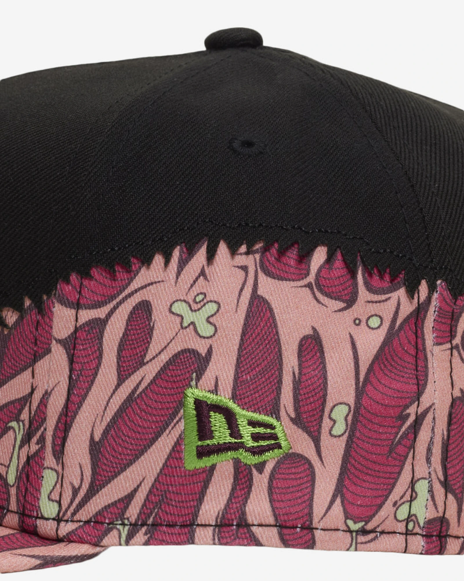 Close-up of New Era Brain 9FIFTY snapback hat featuring pink and burgundy brain graphics, lime green accents and embroidered New Era logo on black.