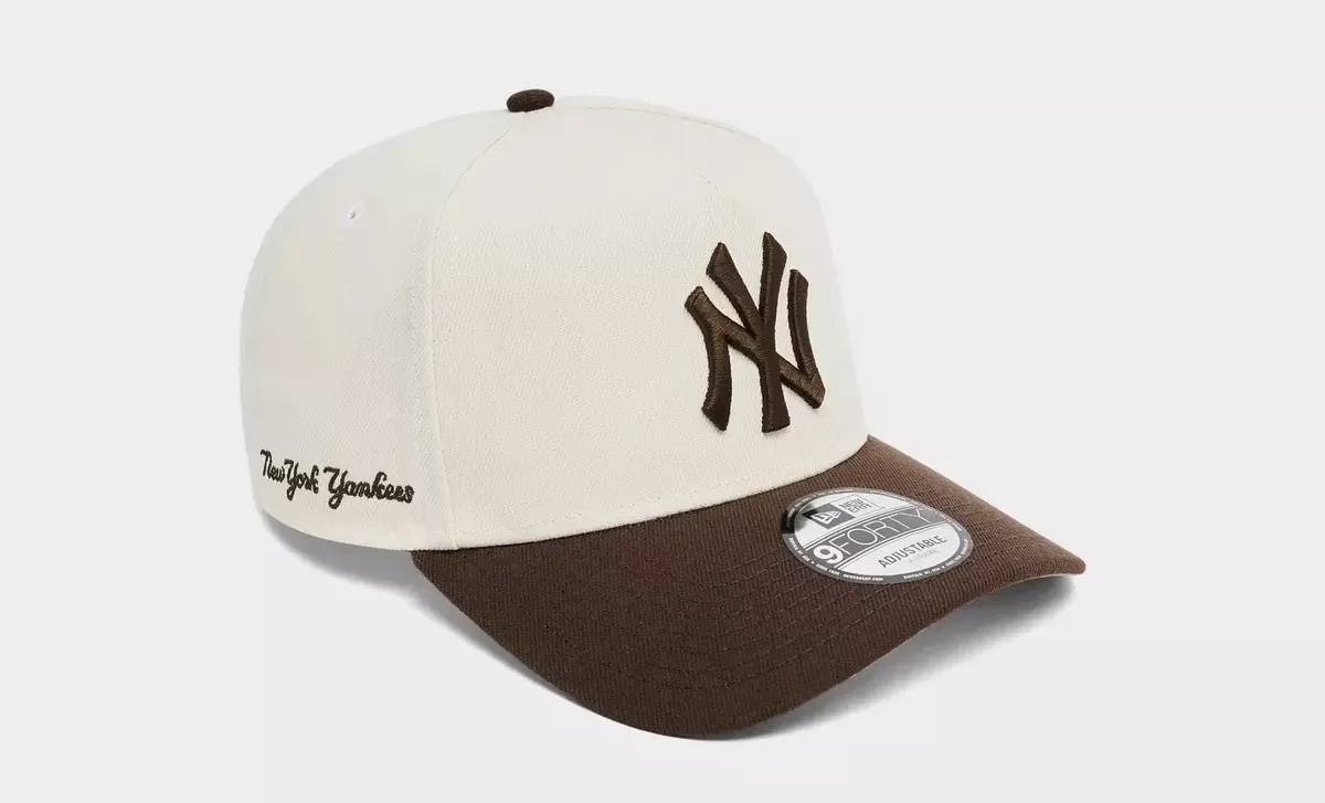 New Era Yankees Chrome/Walnut 9FORTY A-Frame Snapback Hat showing New York Yankees script detail.