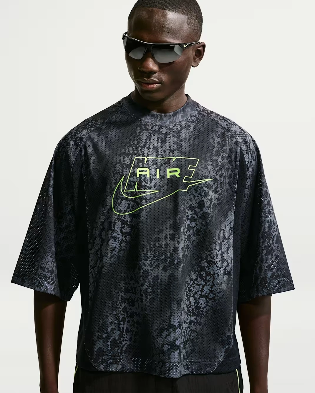 Front view of the Nike Air All-Over Print Mesh Jersey in black, anthracite and Volt with oversized Nike Air graphic