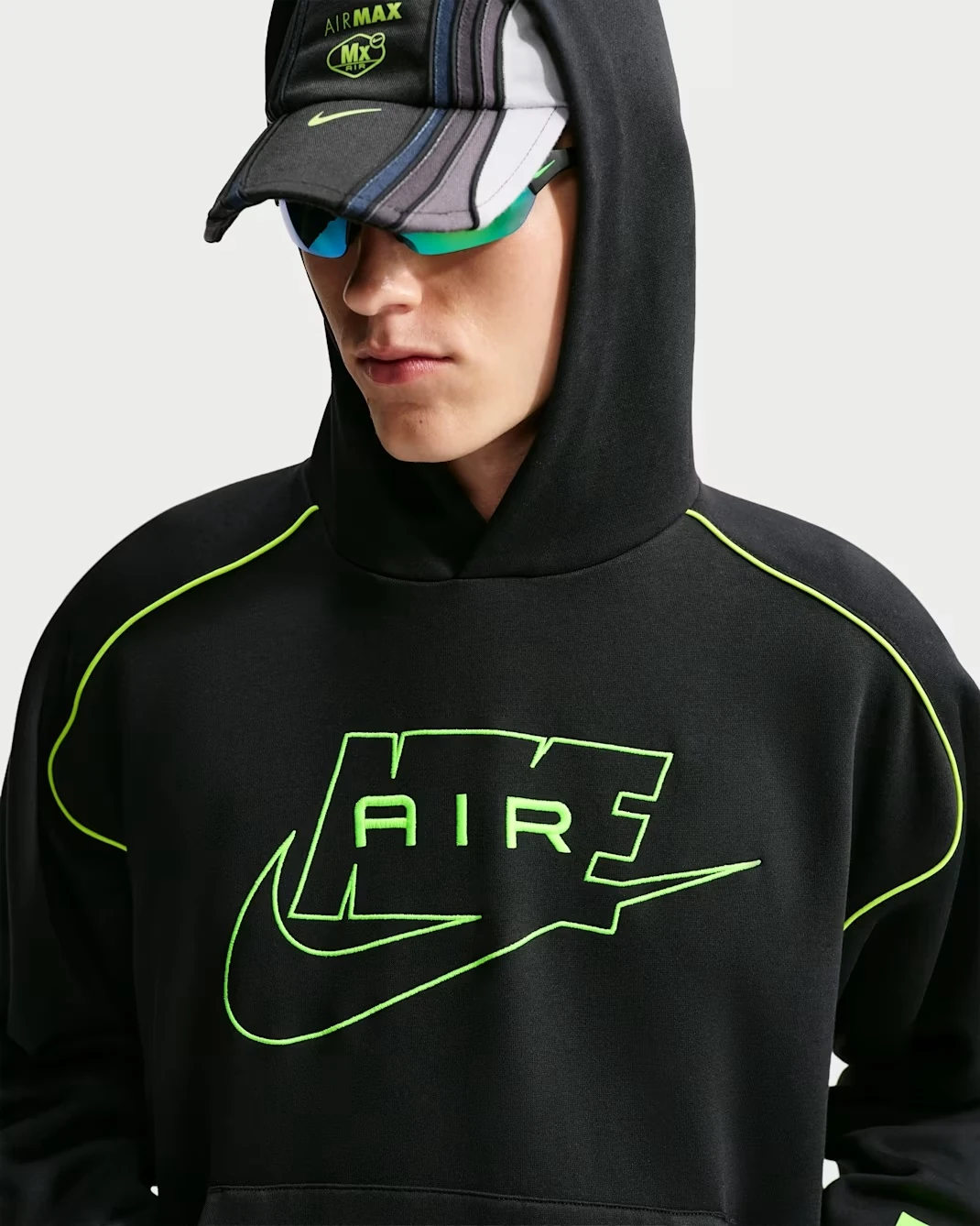 Close-up of the Nike Air Fleece Pullover Hoodie in black with Volt Nike Air logo