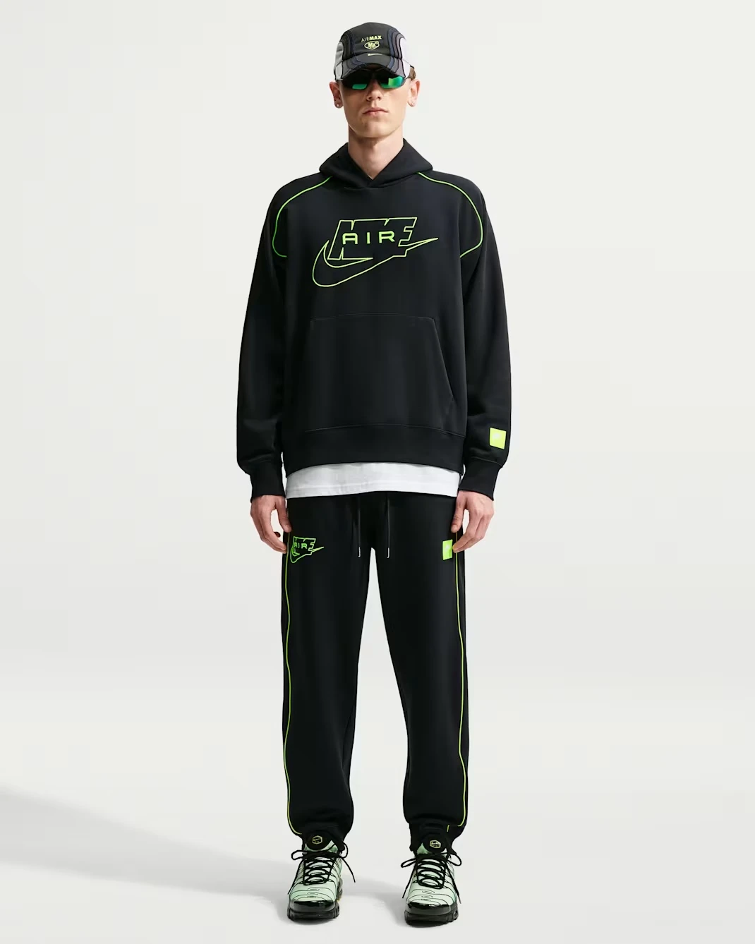 Model wearing the Nike Air Fleece Pullover Hoodie and matching Nike Air Fleece Joggers in black and Volt