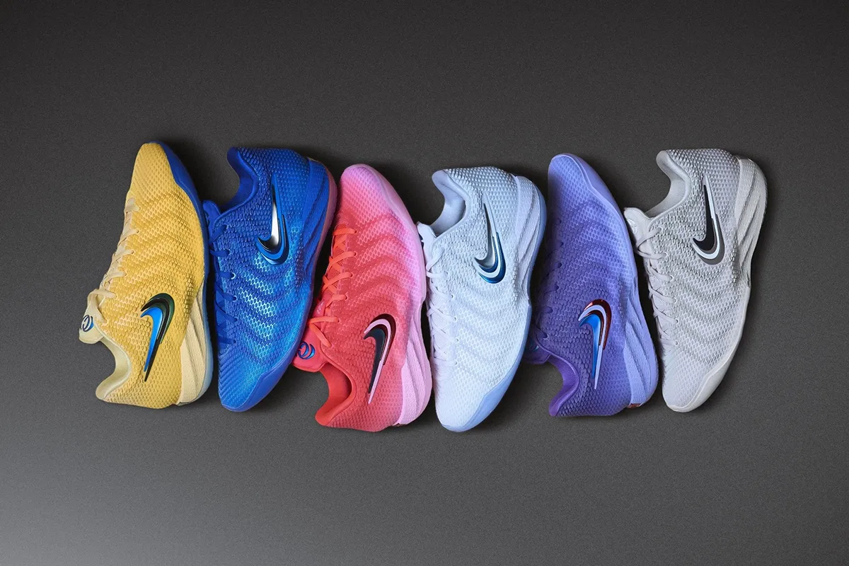 Nike Caitlin 1 Collection featuring yellow, blue, pink, white, purple and grey basketball shoes lined up on a dark background.