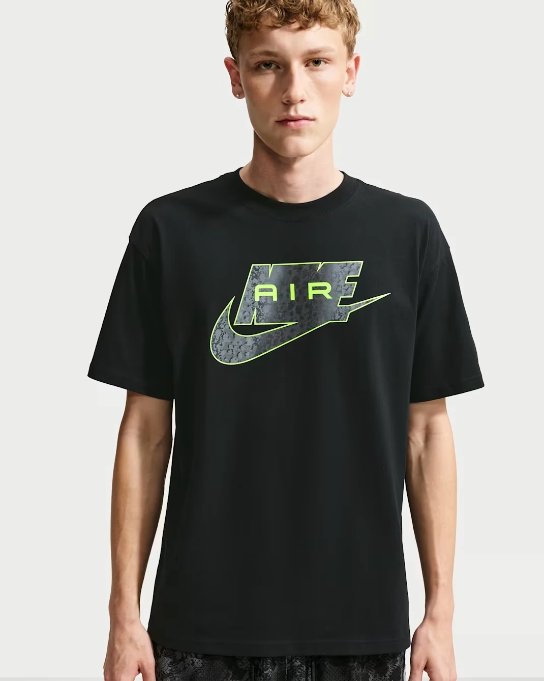 Front view of the Nike Sportswear T-shirt in black with a Volt Nike Air graphic