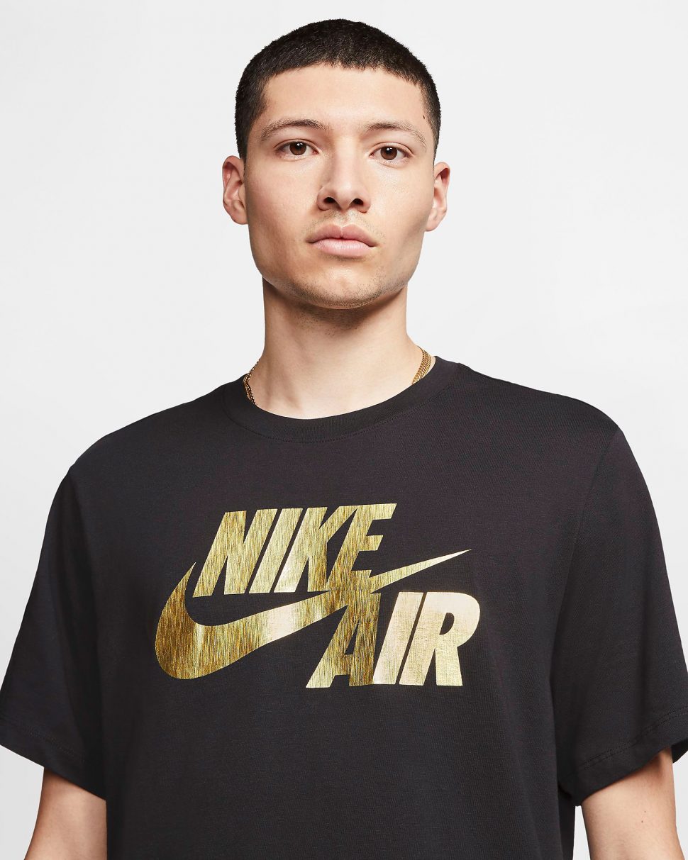 white & gold nike shirt