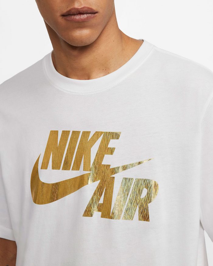 white and gold nike shirt