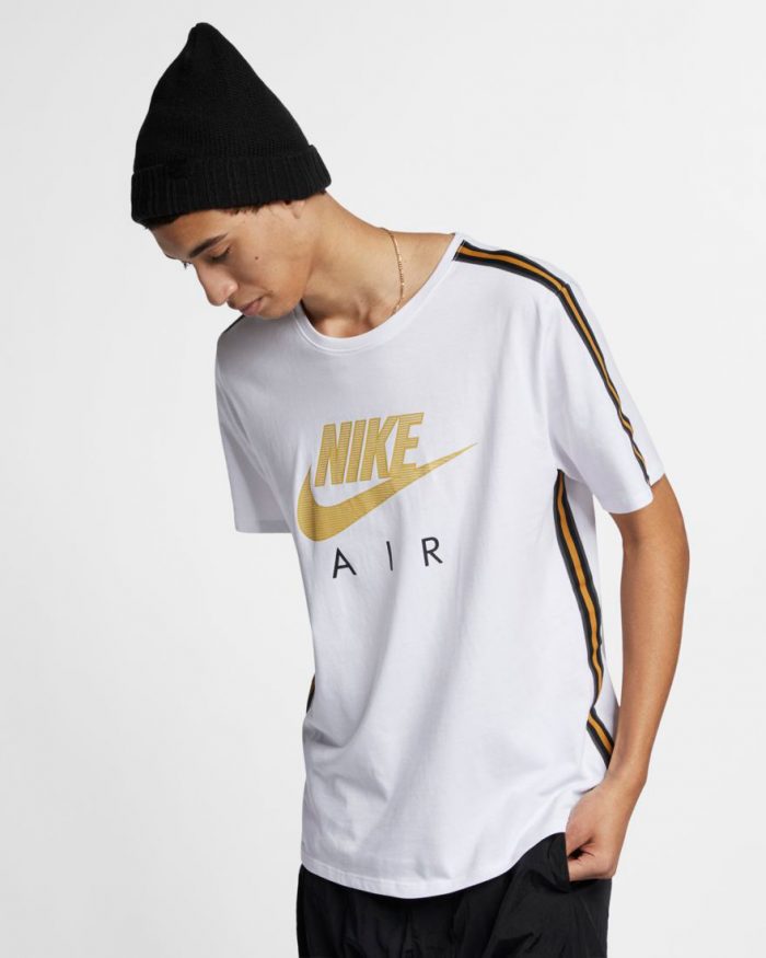 white and gold nike shirt